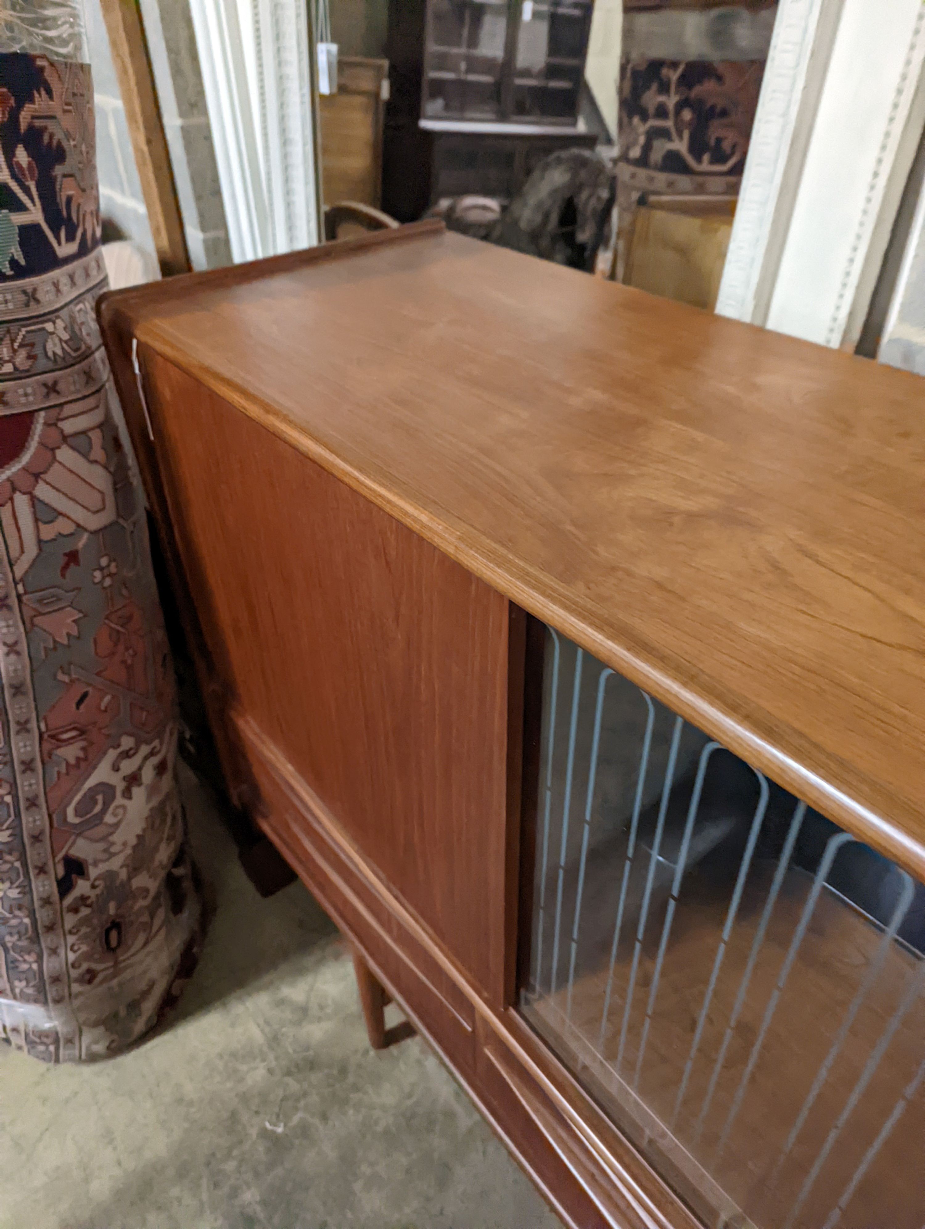 A mid century Danish teak sideboard, length 184cm, depth 44cm, height 115cm